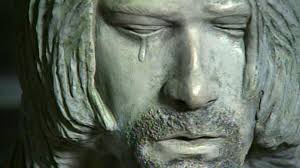 Yes, that is a single tear running down statue-Cobain's cheek. It's meant to represent the kind of maudlin, faux- sentimentality that showed up in his music never.